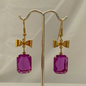 Gold Tone Bow Earrings With Purple Stone